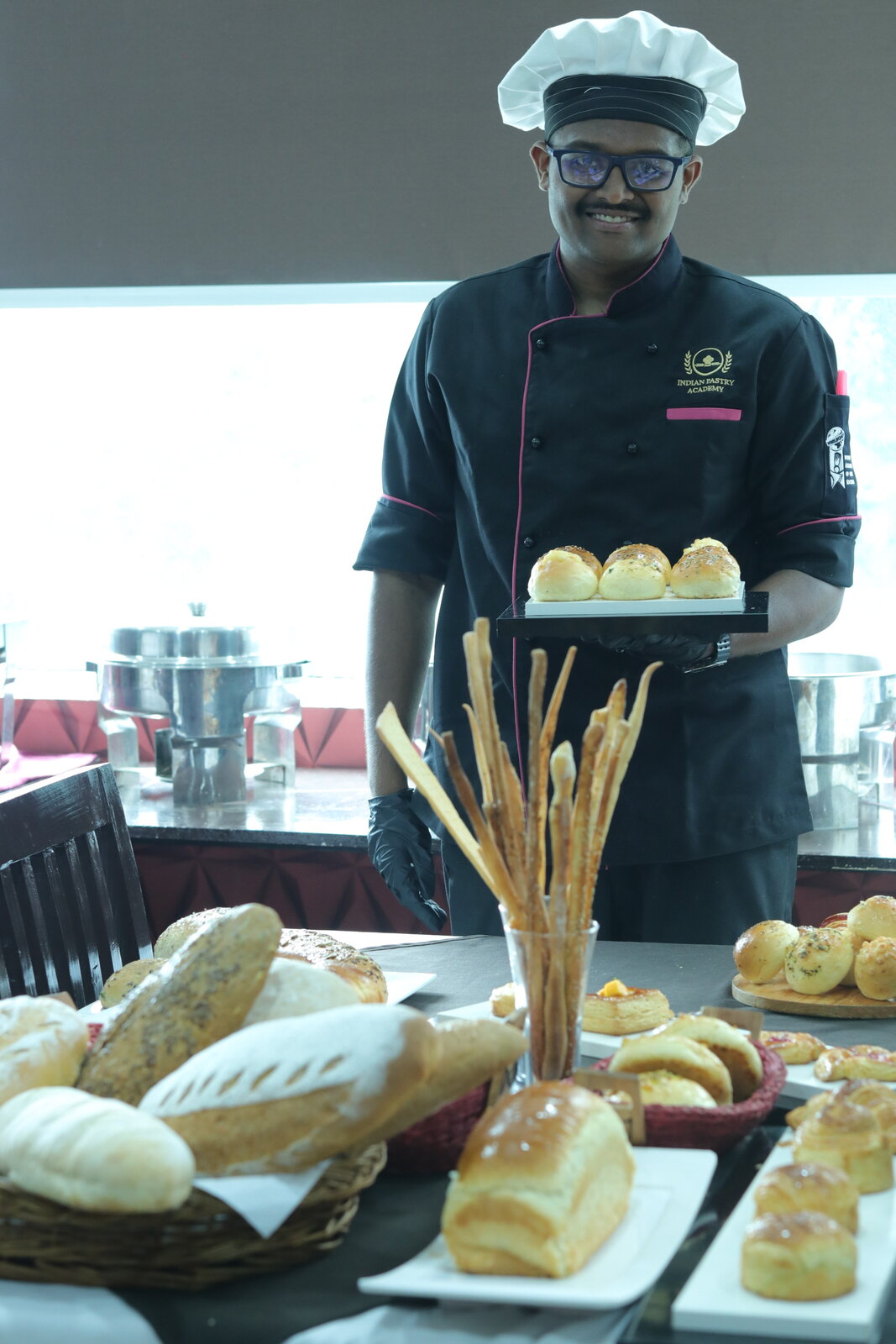 Student presenting a bakery and pastry buffet spread from the B.Voc programme